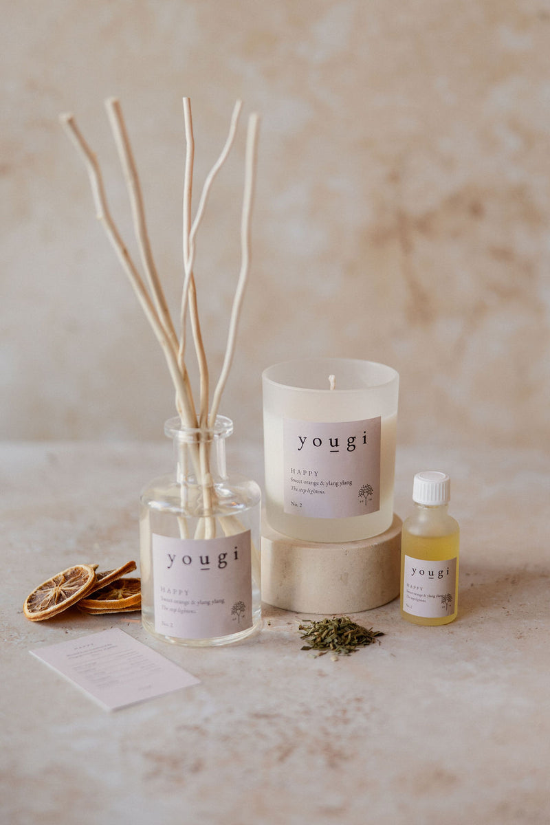 Happy candle, reed diffuser and pure essential oil together on the workshop bench