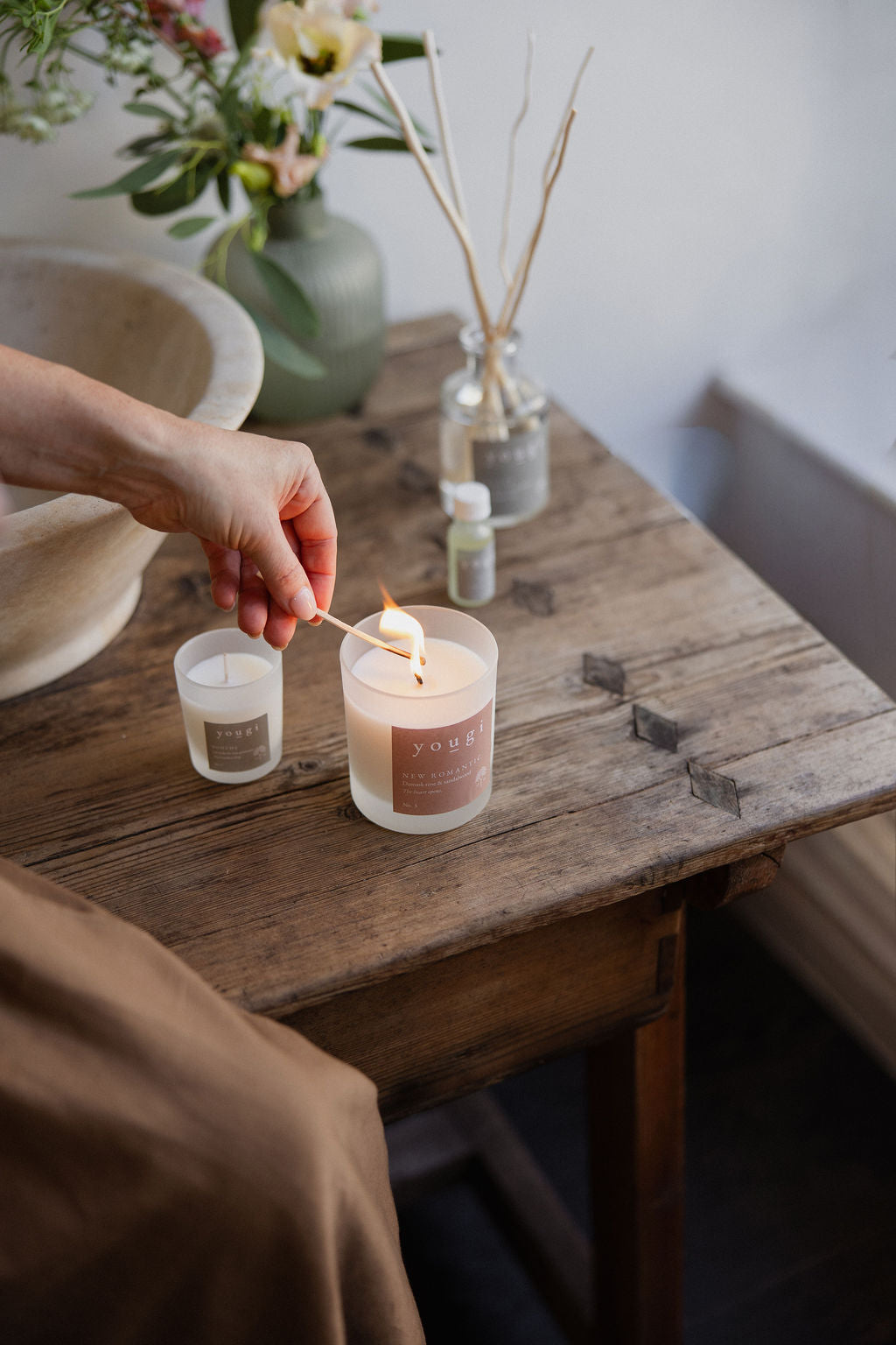 Lighting the small frosted white candles on the studio table