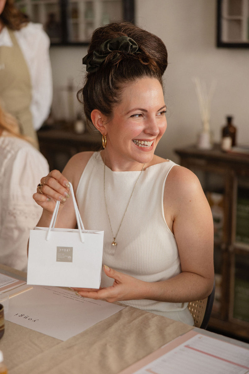 A guest holding a Yougi gift bag at the end of a workshop
