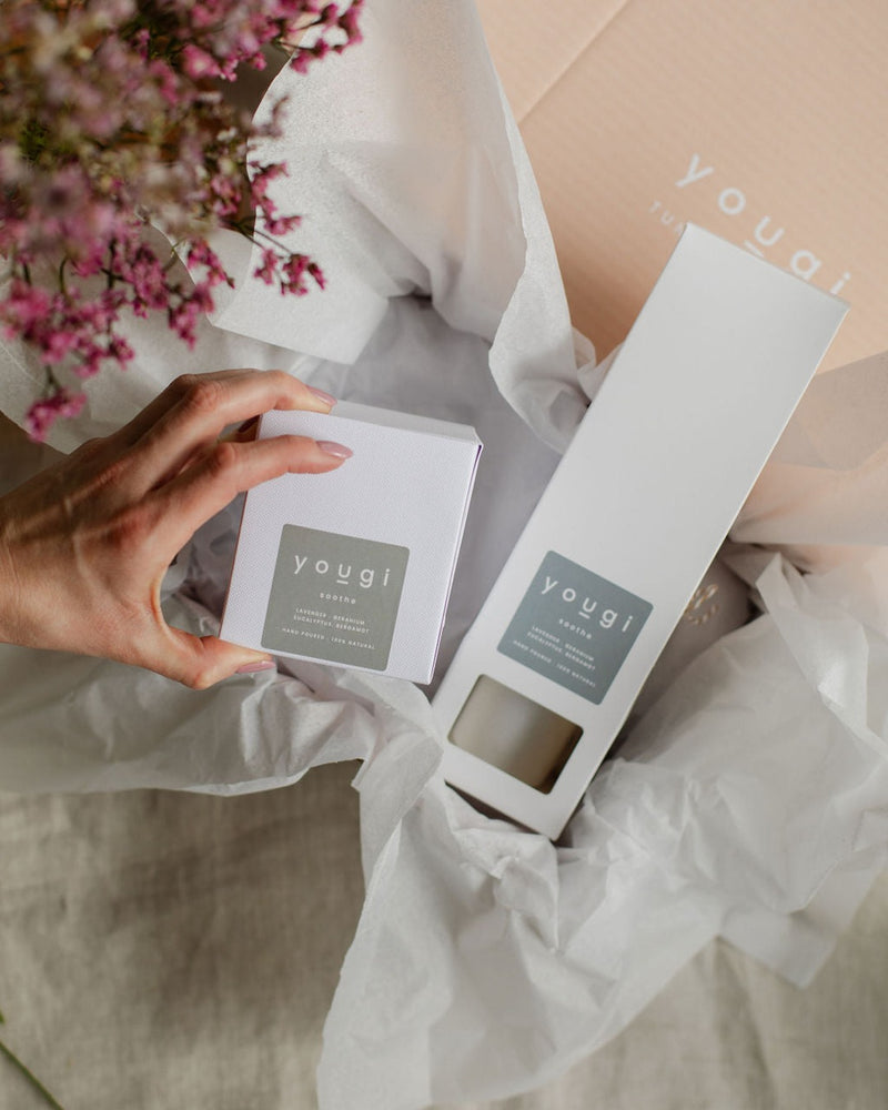The Soothe candle and reed diffuser boxes, labelled lavender, geranium, eucalyptus and bergamot, wrapped in tissue