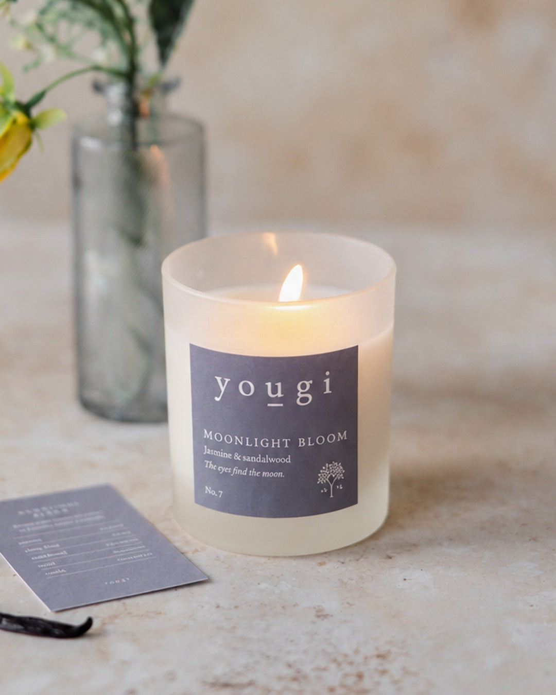Moonlight Bloom candle lit in frosted white glass, with ylang ylang and vanilla