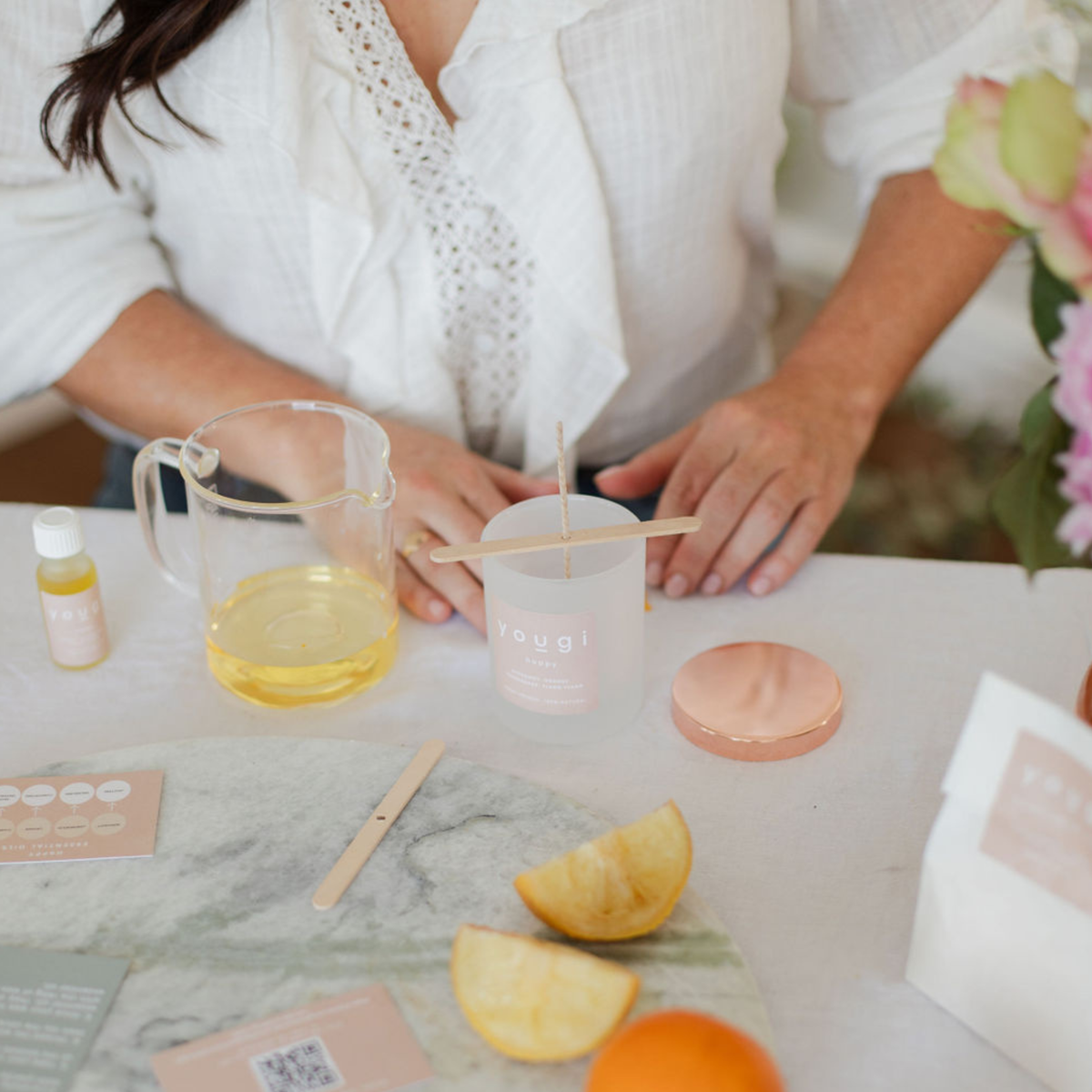 Pouring soy wax into a jar to make a natural candle.