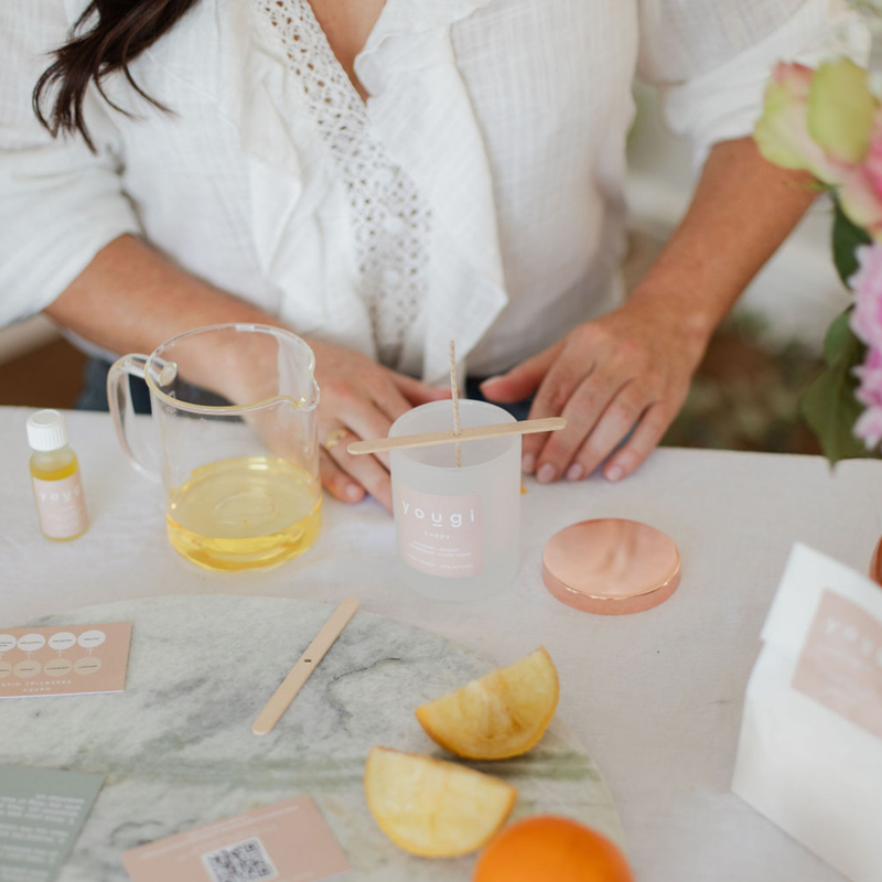 Pouring soy wax into a jar to make a natural candle.