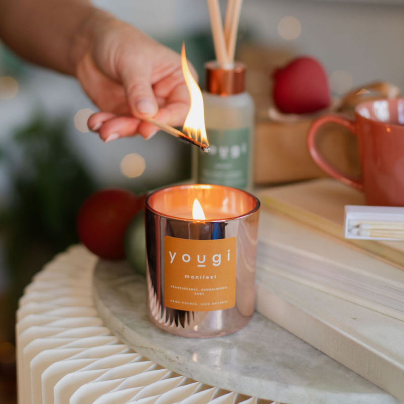 A Manifest candle and diffuser on a shelf.