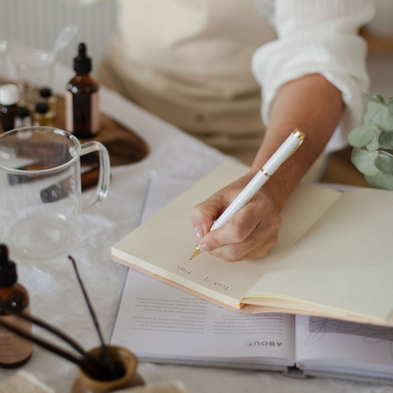 An evening journalling scene with a candle.