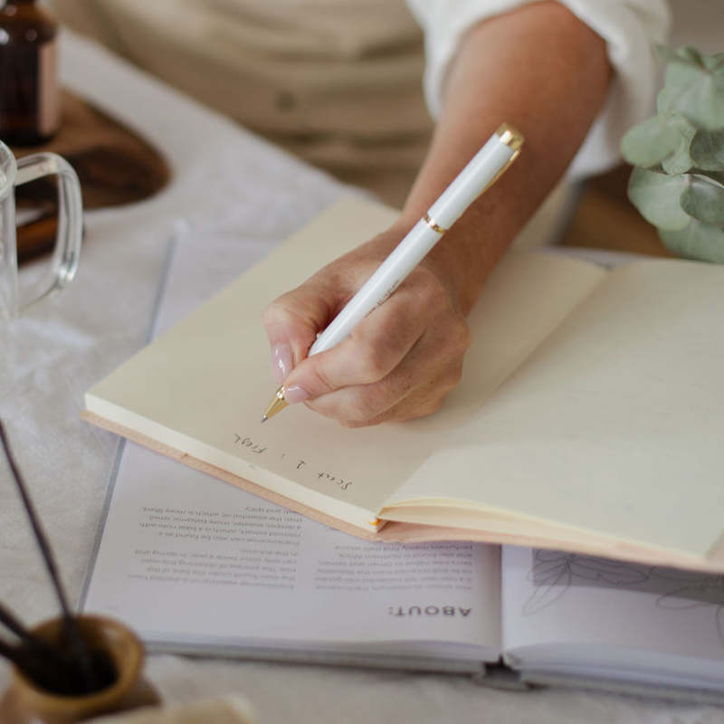 A calm, uncluttered desk with a lit candle.