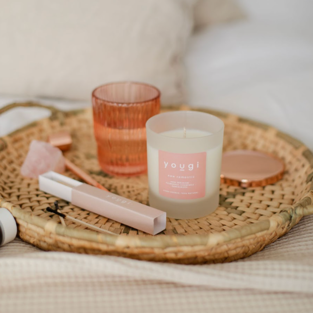 Essential oils and summer botanicals laid out on a table.