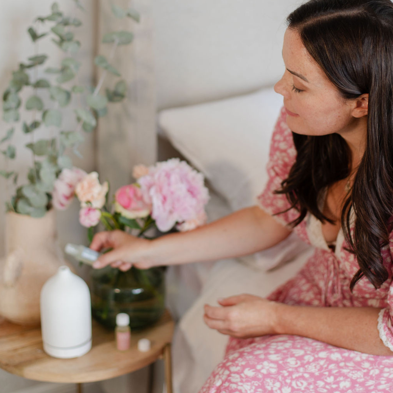 Essential oil bottles and botanicals for aromatherapy.