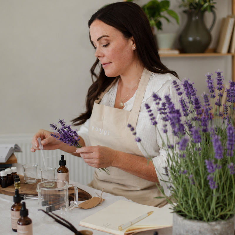 Lavender sprigs beside an amber essential oil bottle.