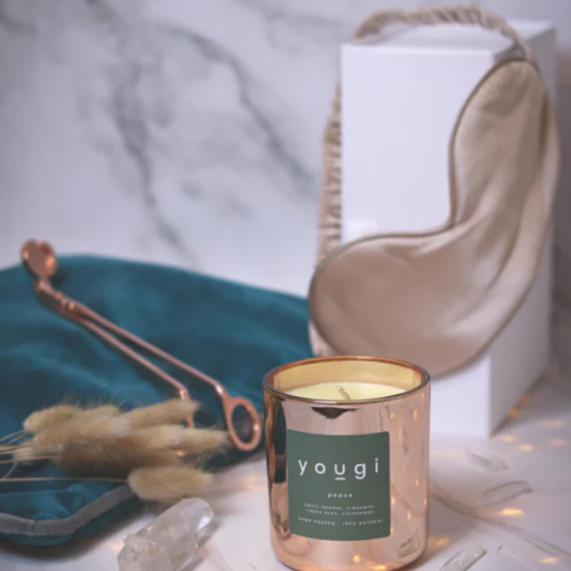 A softly lit bedside scene with a candle.