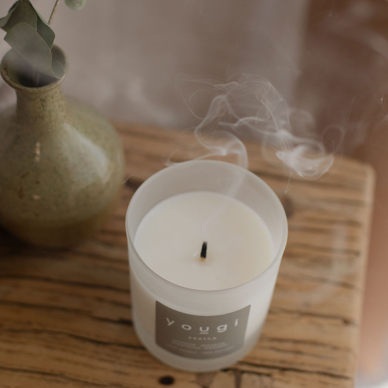 Trimming a candle wick for a clean, long burn.