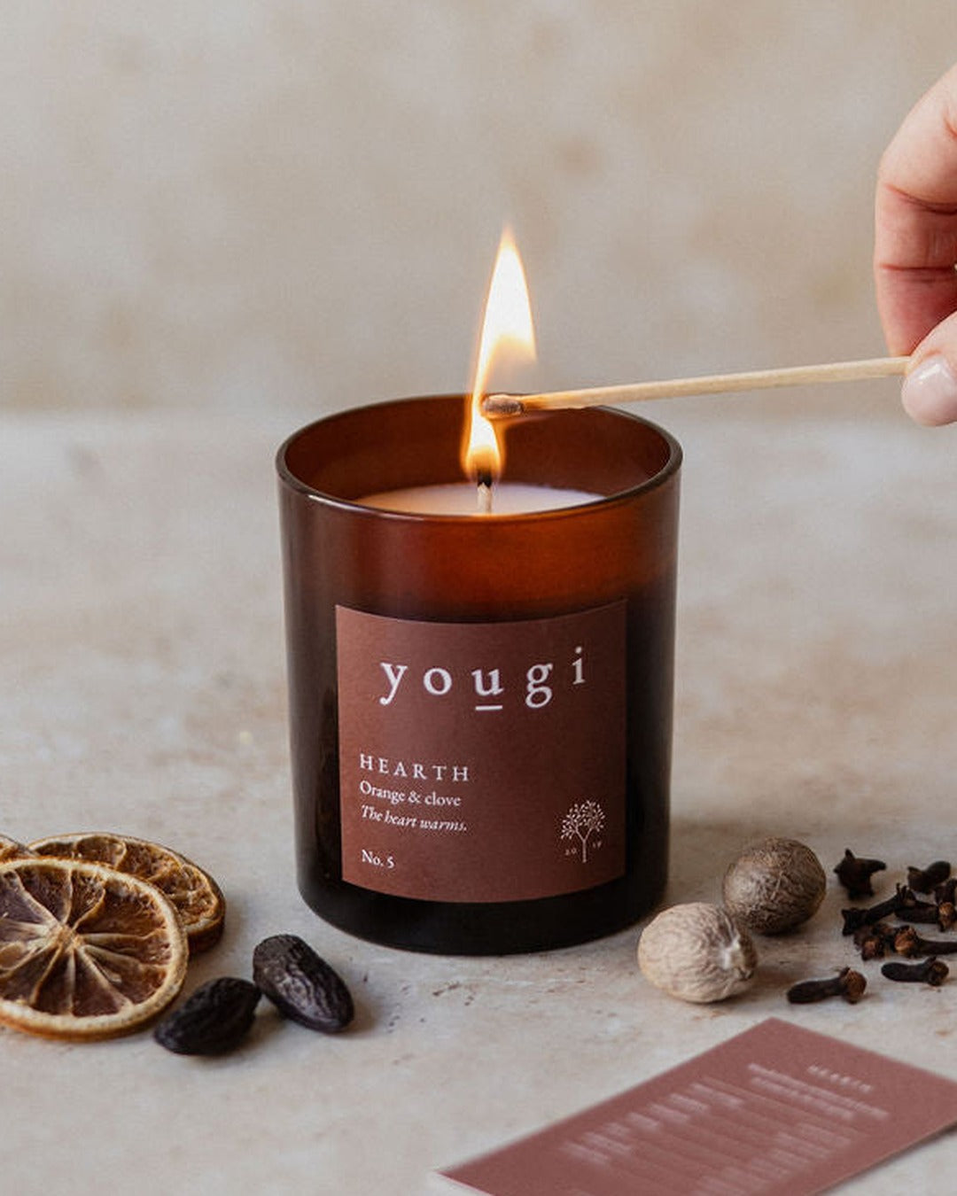 Hearth candle being lit, with dried orange, nutmeg and clove