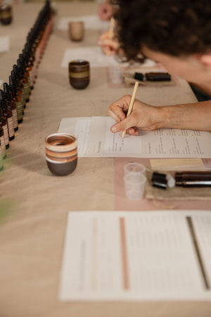 A guest writing her formula at a Yougi perfume workshop