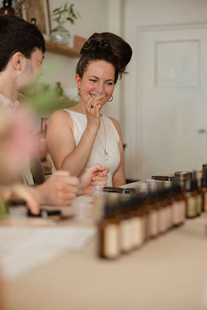 A guest laughing at the table during a Yougi perfume workshop