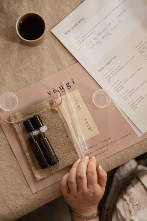 The Yougi perfume-making kit laid out on a linen mat, seen from above