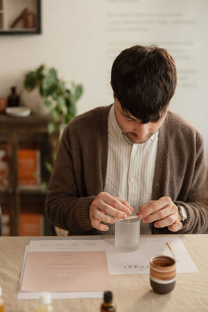 A guest filling a small tin at the bench, Yougi workshop, Connaught Street