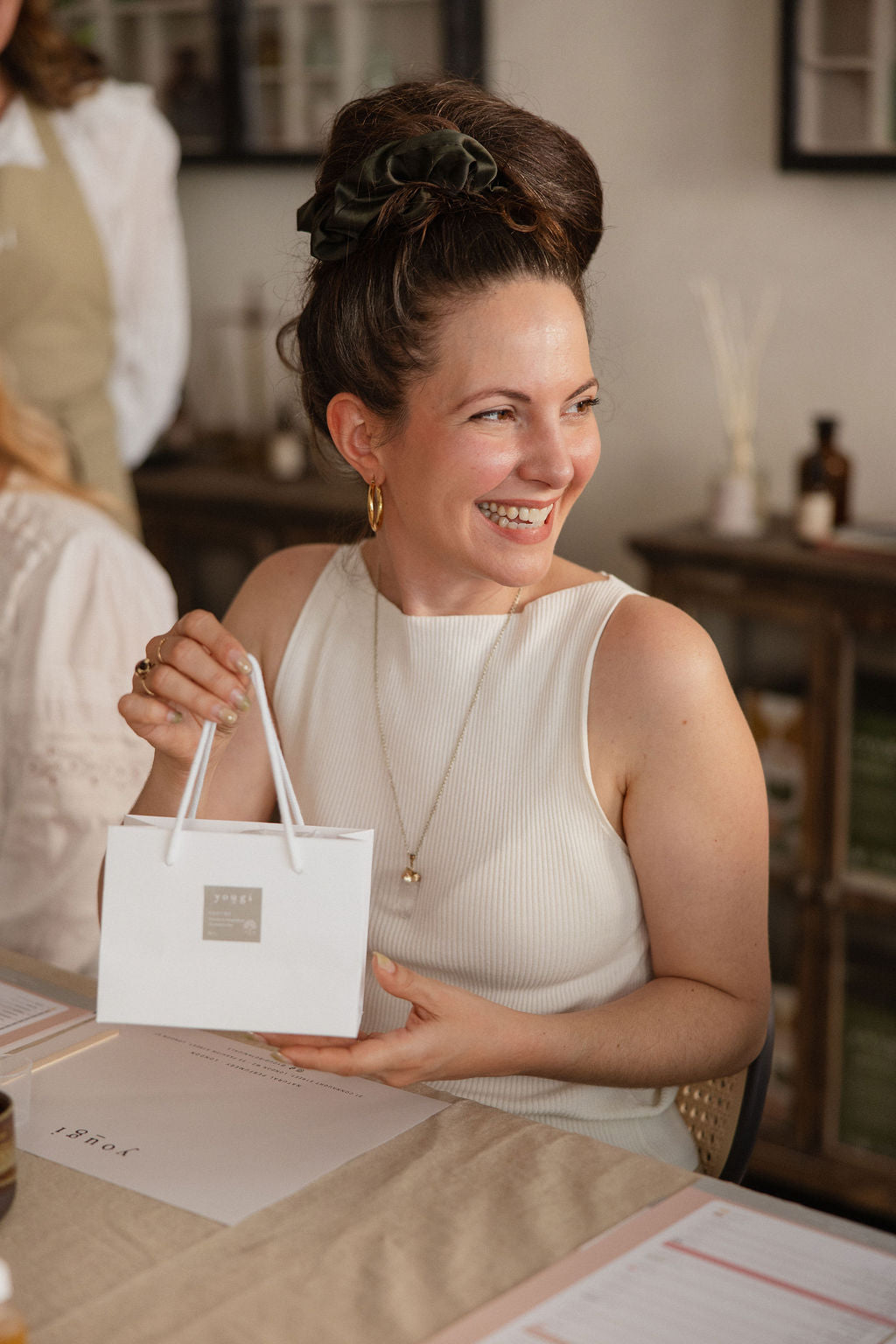 A guest holding a Yougi gift bag at the end of a workshop