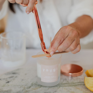 Setting the cotton wick on a hand-poured mini candle