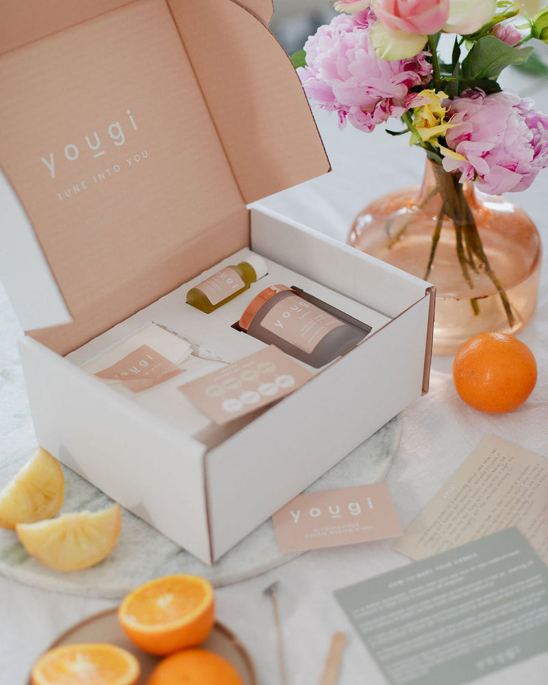 The New Romantic kit box open beside a vase of pink roses, echoing the damask rose in the blend