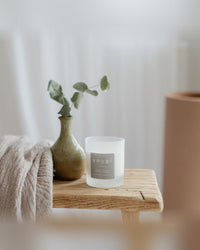 The Soothe scent at home: a lavender and rose geranium candle in a calm, light room