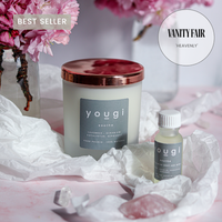 Soothe candle in frosted glass with a grey label, beside its matching essential oil