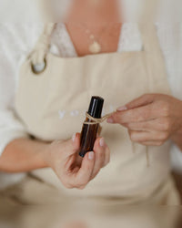Tying a finished roller ball perfume with twine