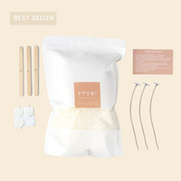 The refill kit contents laid out: eco soy wax, cotton wicks with holders and stickers, wooden stir sticks and the instruction card