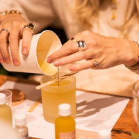 Pouring the melted wax into a frosted glass at the Yougi studio