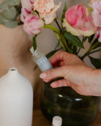 The Soothe blend at home beside fresh peonies