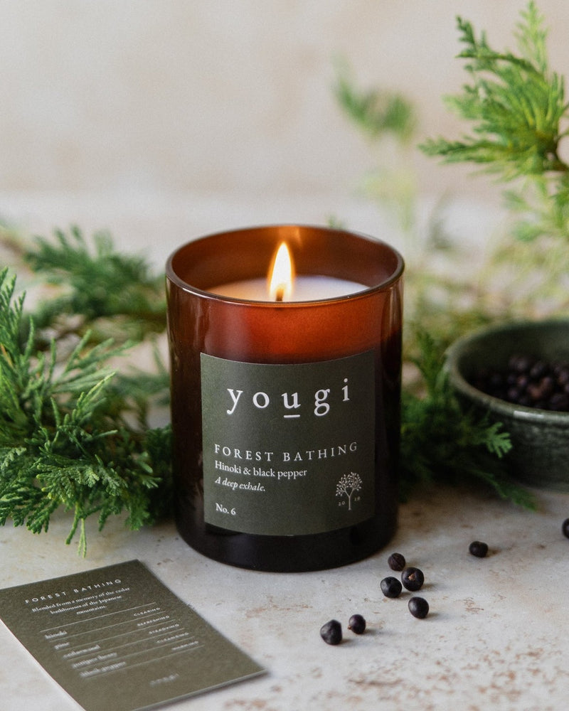 Forest Bathing candle lit in amber glass, with cypress and juniper berries