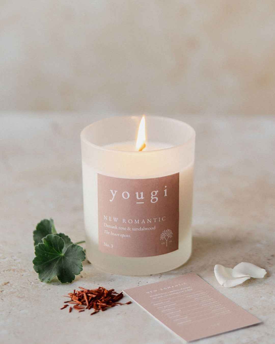 New Romantic candle lit in frosted white glass, with rose petals and sandalwood
