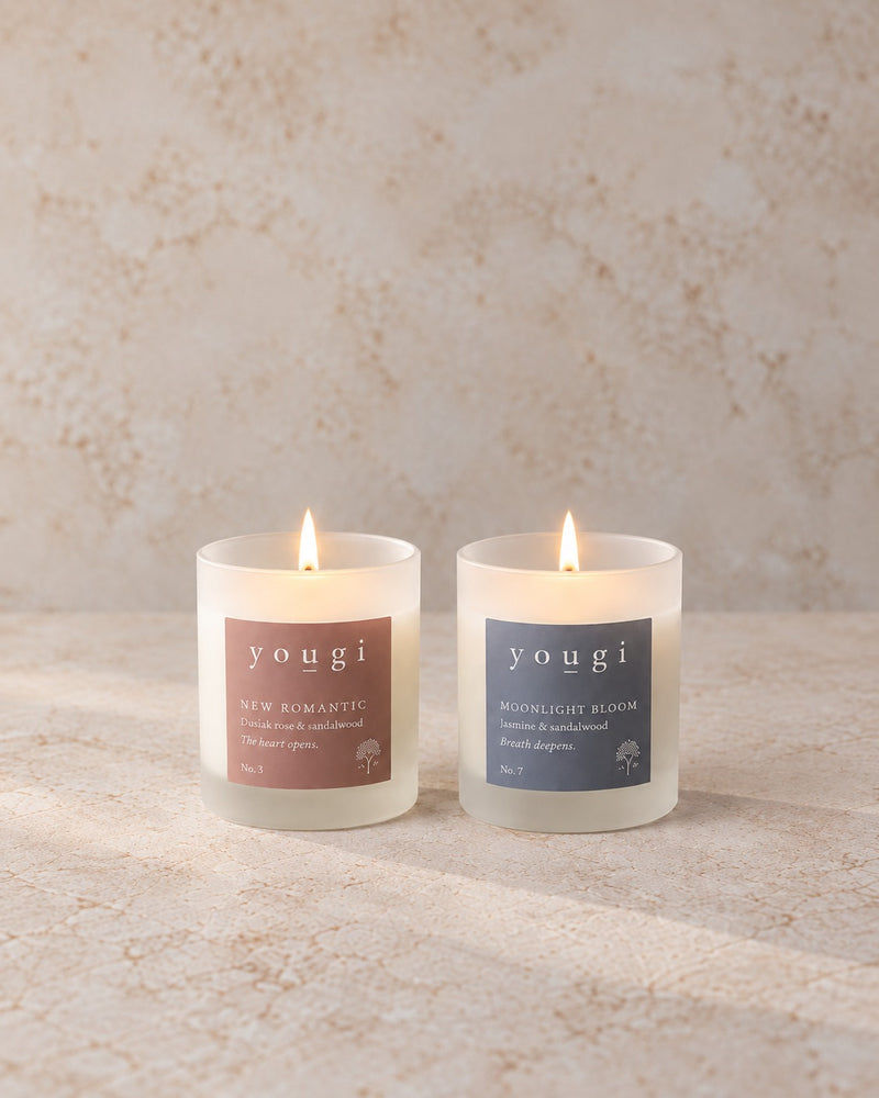 New Romantic and Moonlight Bloom candles lit in frosted white glass