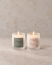 Soothe and Happy candles lit in frosted white glass