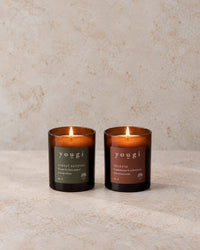 Forest Bathing and Incense candles lit in amber glass