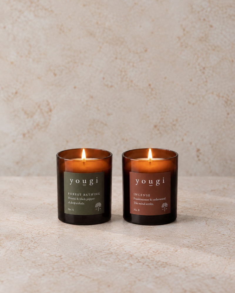 Forest Bathing and Incense candles lit in amber glass