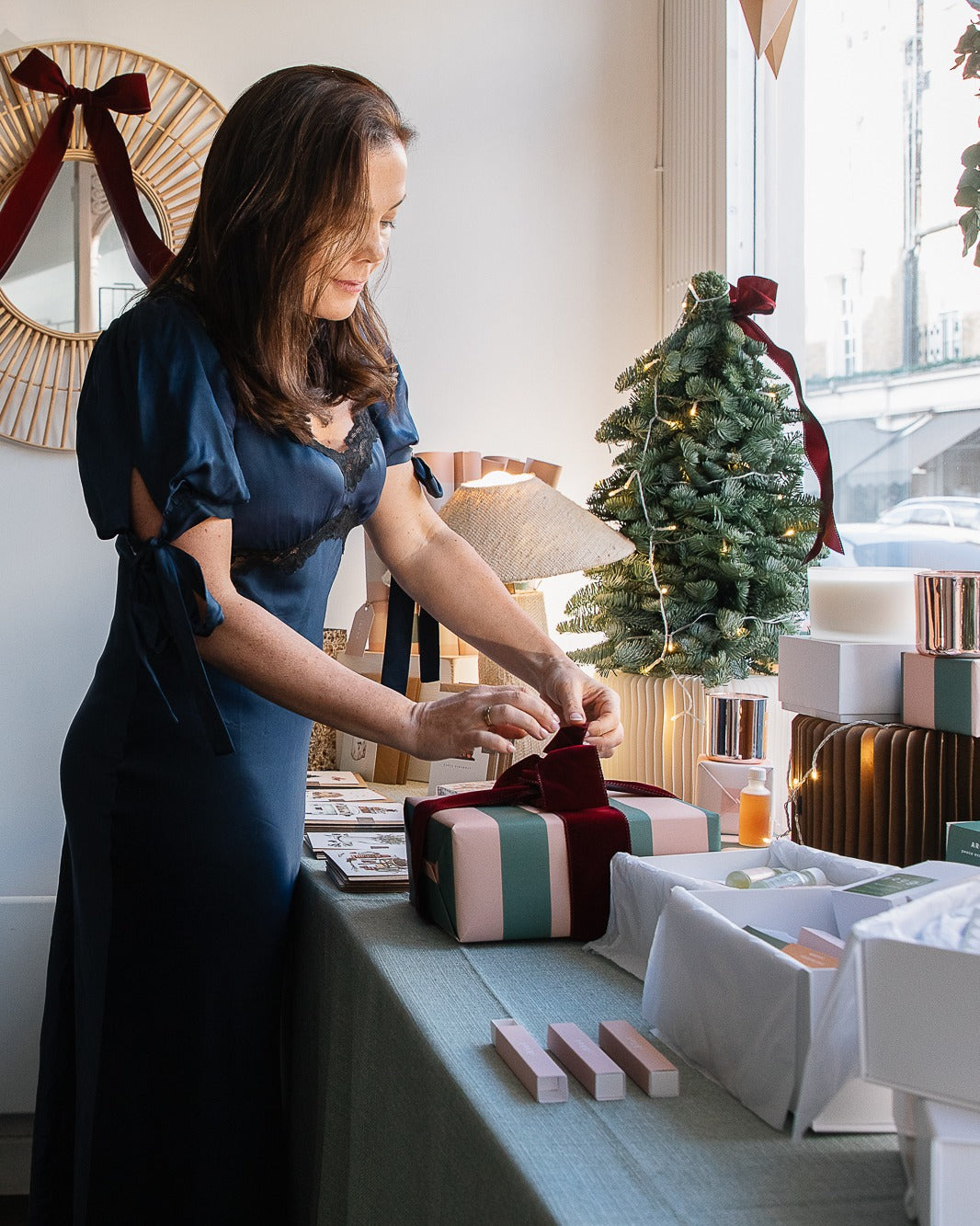 Emily wrapping a gift by the window at the Connaught Street shop